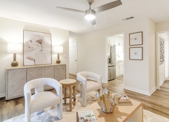 a living room with two chairs and a table at The Oliver Apartment Homes, Olive Branch, MS, 38654