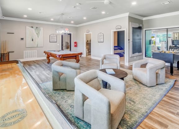 a living room with a pool table and couches at The Vineyard of Olive Branch Apartment Homes, Mississippi