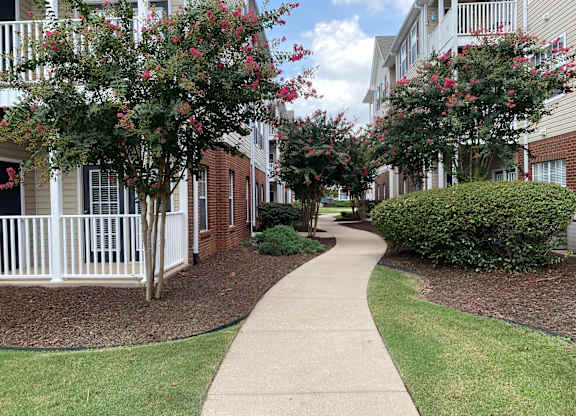 A walkway between two rows of apartment buildings.