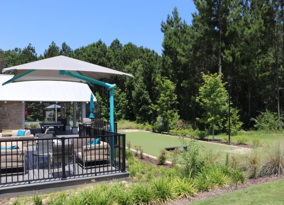 a patio with a gazebo overlooking a golf course and trees at Reserve at Park Place Apartments, Hattiesburg, 39402