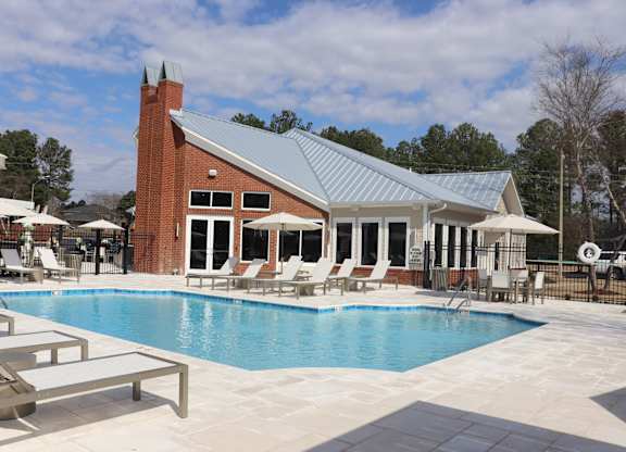 A pool with a building behind it.