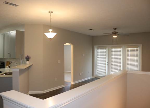 A kitchen with a white counter top and a ceiling fan at Carlton Park Apartment Homes in Flowood, MS