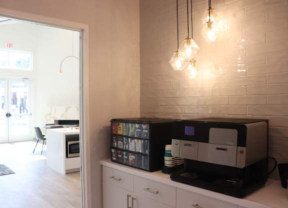 A white brick wall with a coffee machine on top of it.