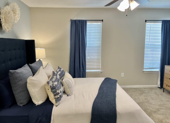a bedroom with a large bed and a ceiling fan at Reserve at Park Place Apartments, Mississippi 39402