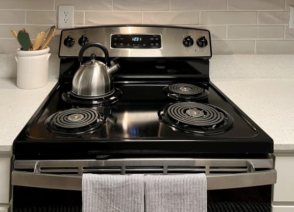 a stainless steel stove with a kettle on top of it at Reserve at Park Place Apartments, Hattiesburg, 39402