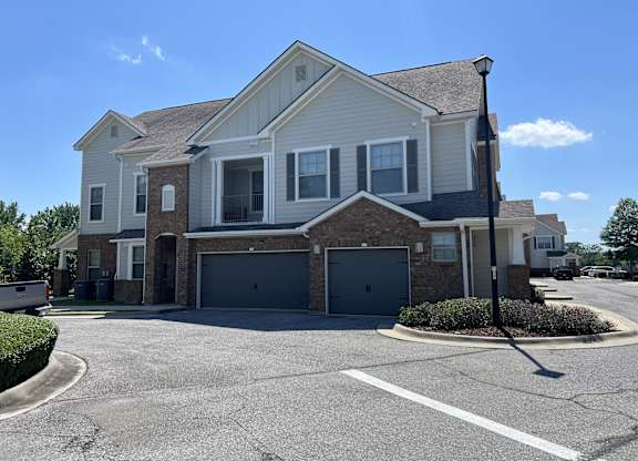 A large house with a grey garage door at Audubon Park Apartment Homes, LA