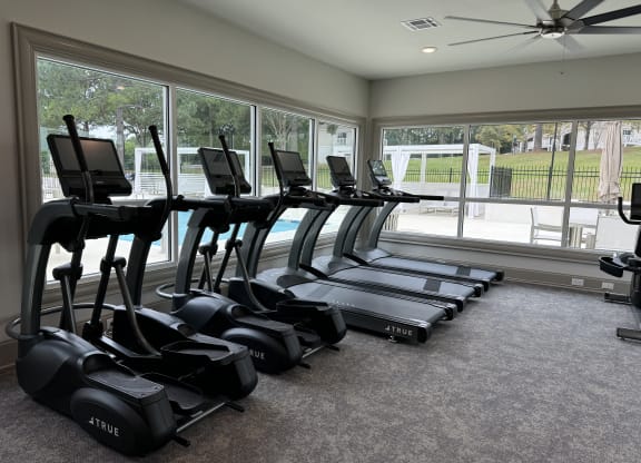 a gym with cardio machines and a large window at Laurelwood Apartment Homes, Laurel, Mississippi, 39440