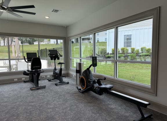 a home gym with exercise equipment and large windows at Laurelwood Apartment Homes, 39440