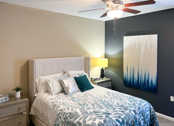 a bedroom with a bed and a ceiling fan at Canebrake Apartment Homes in Shreveport, Louisiana, 71115