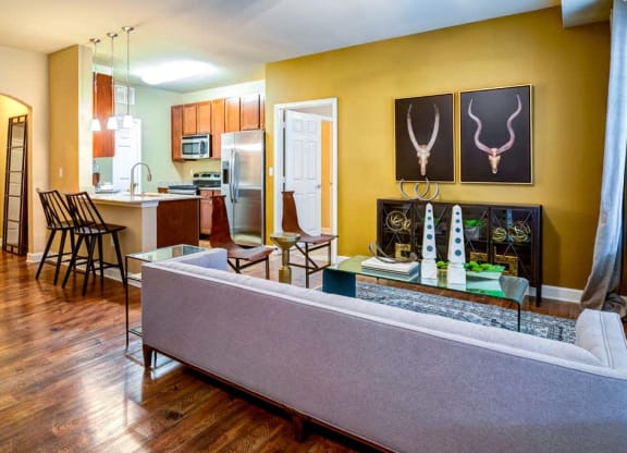 a living room with a couch and a table at The Retreat Apartment Homes in ND 58801