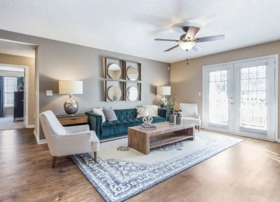 a living room with a couch and a ceiling fan at Reserve at Gulf Hills Apartment Homes in Ocean Springs, MS 