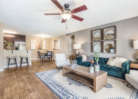 a living room with a couch and a ceiling fan at Reserve at Gulf Hills Apartment Homes in Ocean Springs, MS 39564