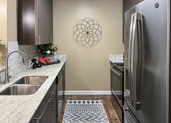 a kitchen with stainless steel appliances and granite counter tops at Reserve of Bossier City Apartment Homes in Louisiana 71111
