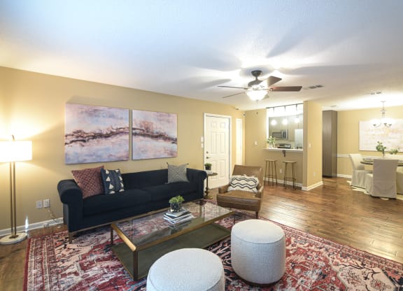 a living room with a couch and a ceiling fan at Reserve of Bossier City Apartment Homes in Bossier City, Louisiana