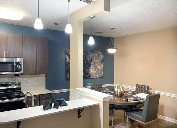 an open kitchen and dining room with a table and chairs at Canebrake Apartment Homes, Louisiana, 71115