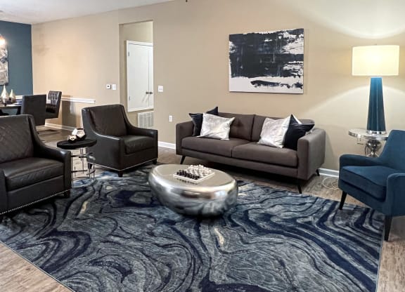 a living room with couches and chairs and a rug at Canebrake Apartment Homes in Shreveport, LA, 71115