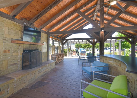 a covered patio with a fireplace and benches at Reserve of Bossier City Apartment Homes in Bossier City, Louisiana 71111
