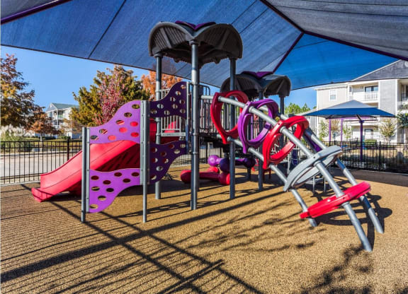 our playground is equipped with a variety of equipment including slides and swings at Reserve at Gulf Hills Apartment Homes in Ocean Springs, MS 