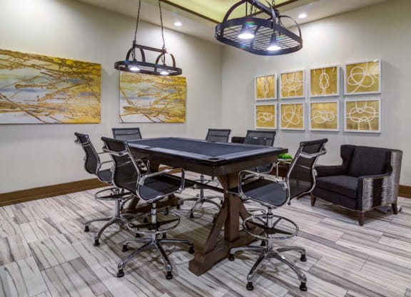 a conference room with a table and chairs at The Retreat Apartment Homes in Williston, North Dakota 58801