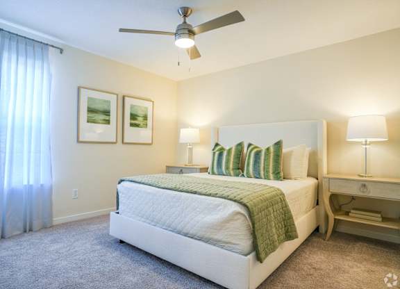 a bedroom with a bed and a ceiling fan at The Vineyard at Castlewoods Apartment Homes in Brandon, MS 39047