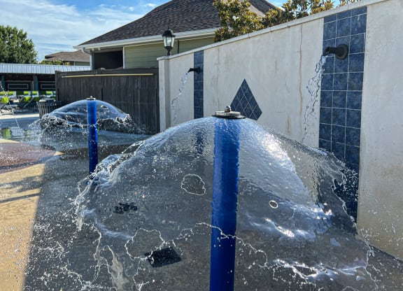 a fountain overflowing with water in front of a house at Canebrake Apartment Homes in Shreveport, LA, 71115