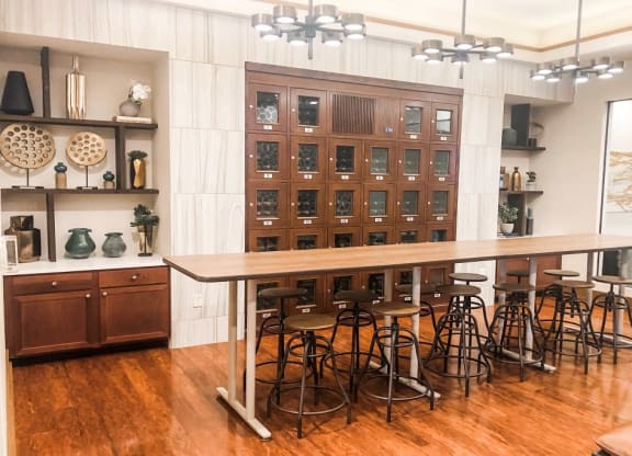 a kitchen with a table and chairs in front of a cabinet at The Retreat Apartment Homes in Williston, ND 