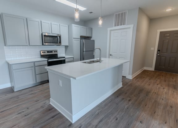 an open kitchen with a large island in the middle