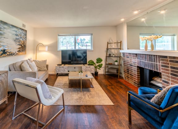 a living room with a fireplace and a tv