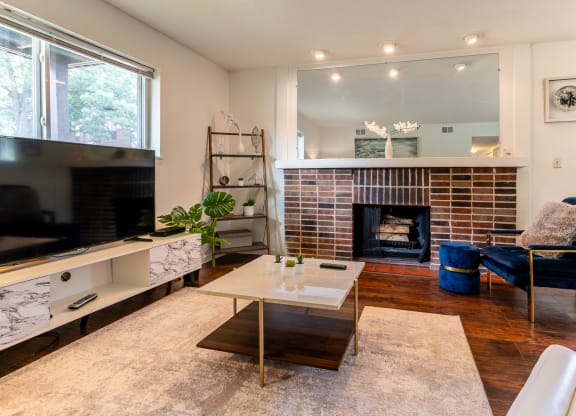 a living room with a fireplace and a television