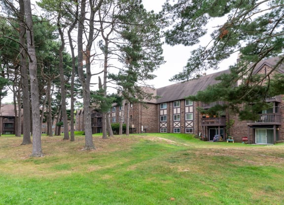 a large brick building with trees in front of it