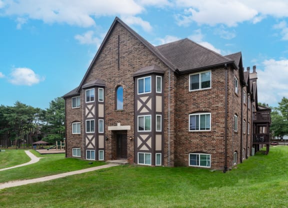 an apartment building with a brick exterior and a brown and tan facade