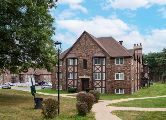 a large brick building with a sidewalk in front of it
