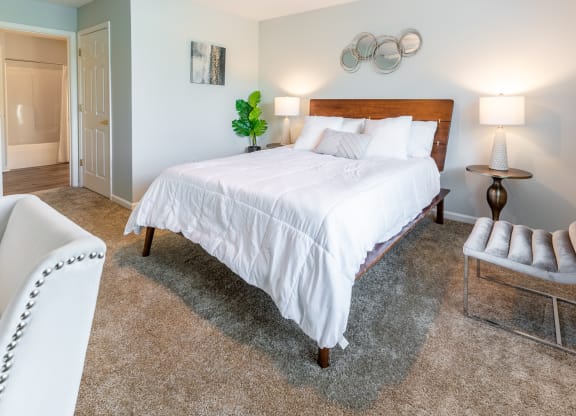 a bedroom with a bed and a chair and a closet