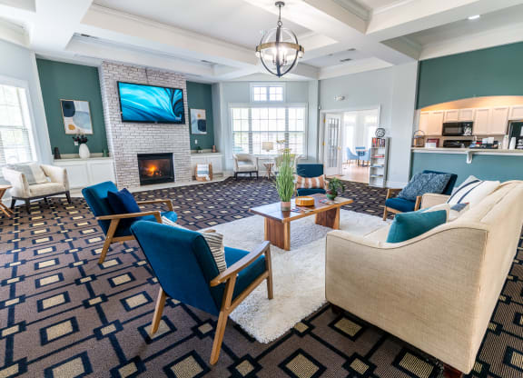 a living room with a couch and chairs and a fireplace