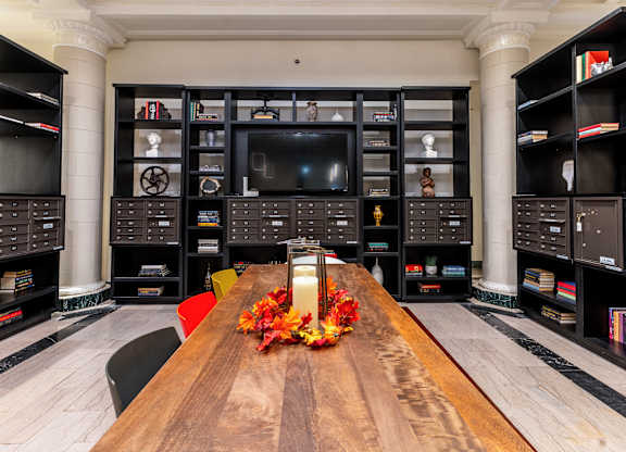 a living room with a large wooden table and a television