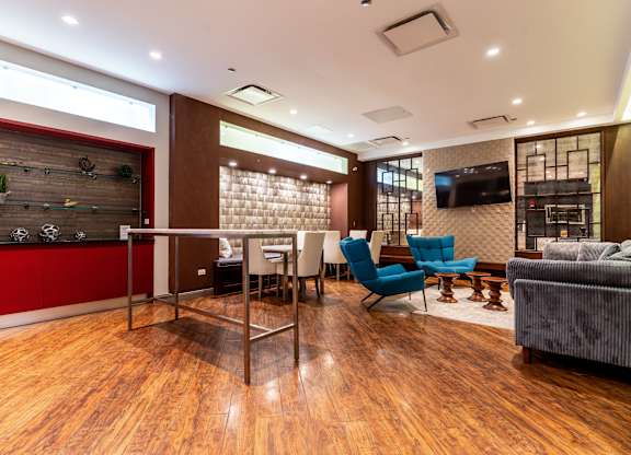 a conference room with a table and chairs and a television