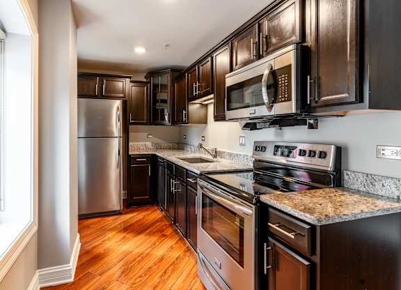 a kitchen with stainless steel appliances and granite counter tops