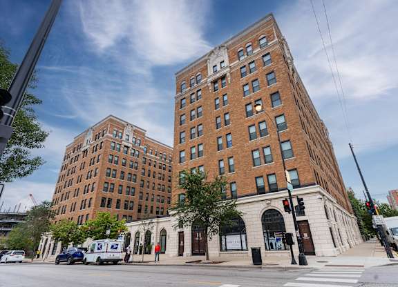 a tall brick building on the corner of a city street