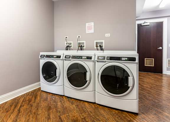 a washer and dryer in a laundry room with two washing machines