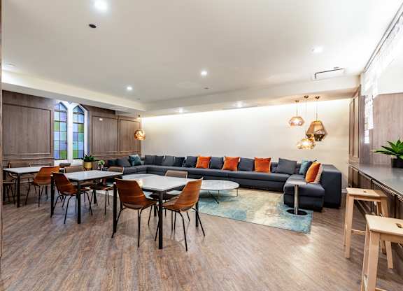 a living room with couches and tables and chairs at Park Heights by the Lake Apartments, Illinois
