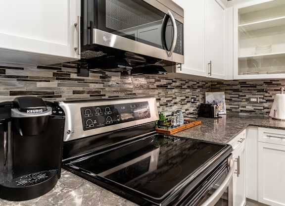 private kitchen with stainless steel appliances and a granite counter top at Park Heights by the Lake Apartments, Chicago, 60649