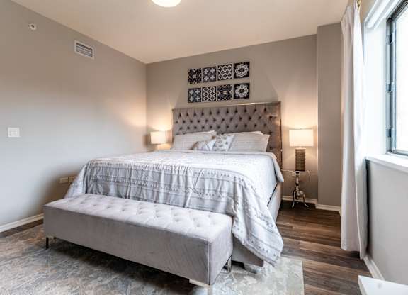 a bedroom with a bed and a window at Park Heights by the Lake Apartments, Chicago, 60649