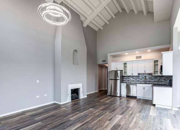 a living room with a fireplace and a kitchen at Park Heights by the Lake Apartments, Chicago, 60649