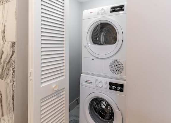 a small laundry room with a washing machine and a dryer at Park Heights by the Lake Apartments, Chicago, IL