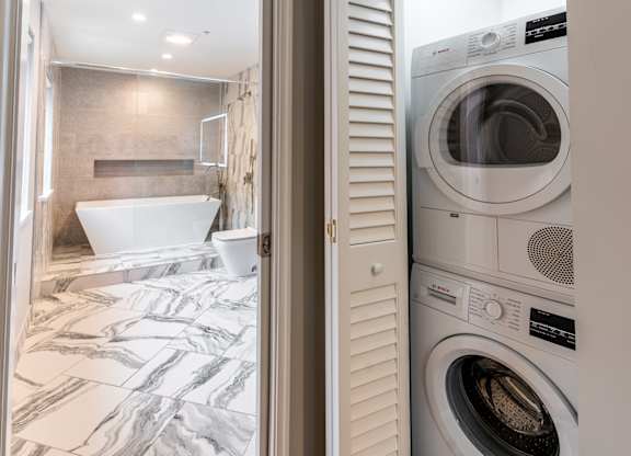 a small laundry room with a washer and dryer at Park Heights by the Lake Apartments, Chicago, Illinois