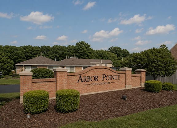 A sign that says Arbor Pointe is in front of a building.