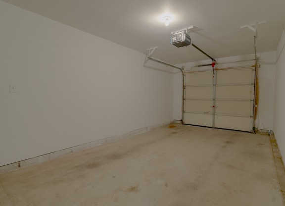 a room with a white wall and a garage door