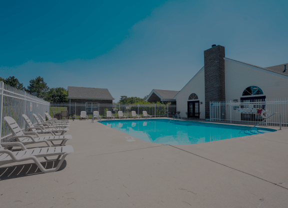 our resort style swimming pool is next to our building with lounge chairs