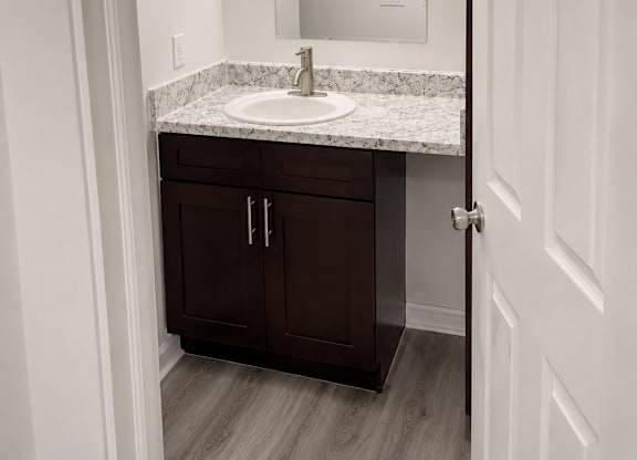 A bathroom with a sink and mirror.