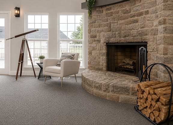 A room with a fireplace and a chair.